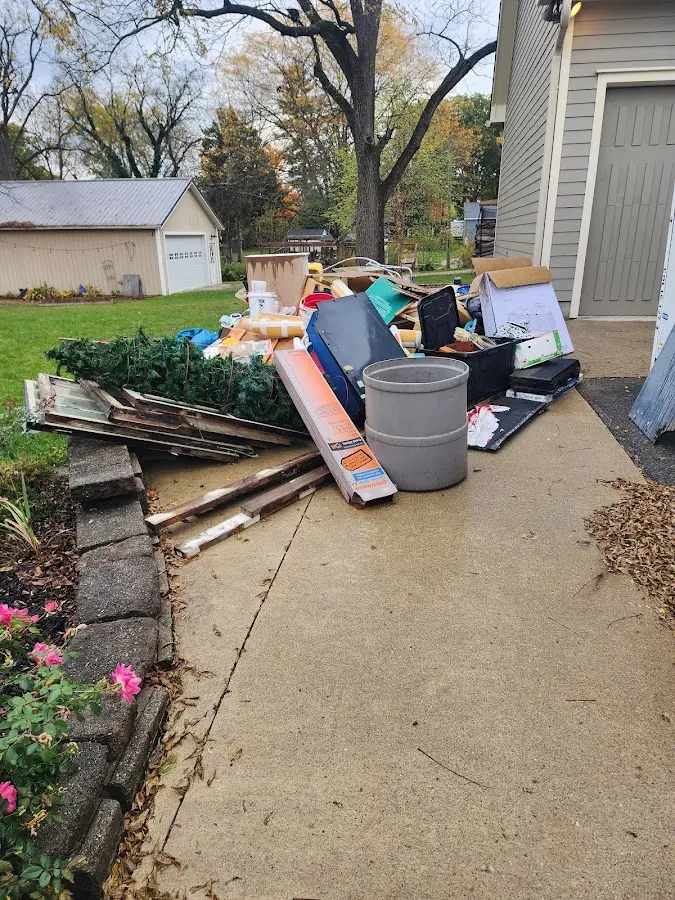 Dumpster being loaded with debris for Residential Dumpster Rental in Windsor